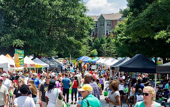 A large group of people at an outdoor festival in Peachtree Corners.